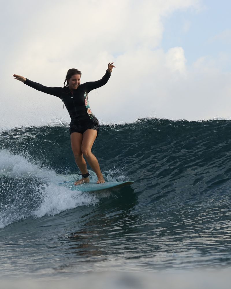 A surfer riding a long open wall at Chickens