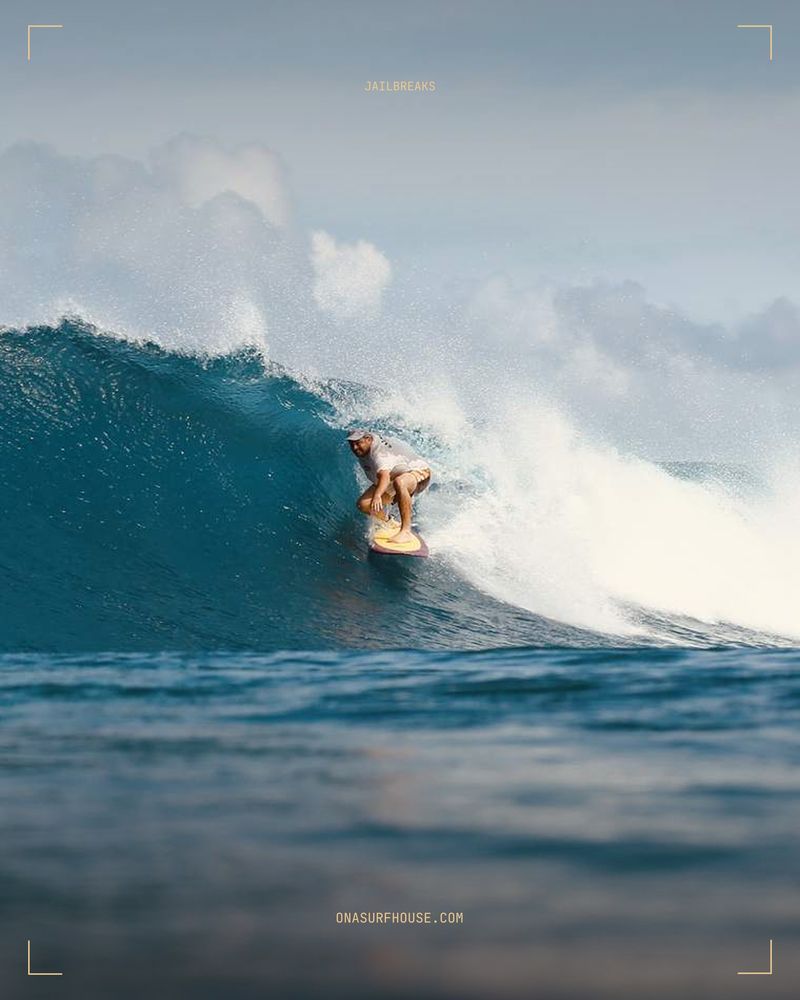 A surfer dropping into a steep wall at Jailbreaks